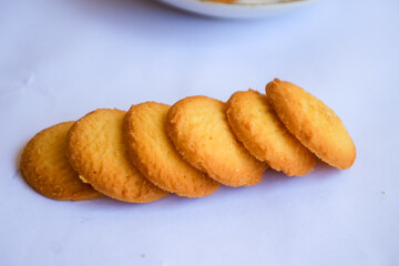 Danish butter cookies, stack of golden chocolate butter cookies isolated on white background, sweet pastry