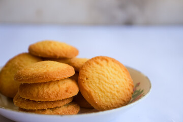 Danish butter cookies, stack of golden chocolate butter cookies isolated on white background, sweet pastry