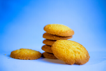 Danish butter cookies, stack of golden chocolate butter cookies isolated on white background, sweet pastry