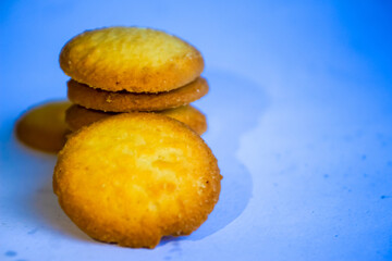Danish butter cookies, stack of golden chocolate butter cookies isolated on white background, sweet pastry