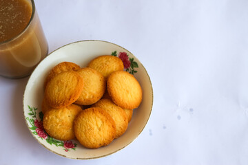 breakfast menu in the form of Danish butter cake and a glass of chocolate milk, Close up of butter cookies coated with white sugar and a glass of chocolate, sweet cake