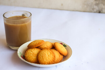 breakfast menu in the form of Danish butter cake and a glass of chocolate milk, Close up of butter cookies coated with white sugar and a glass of chocolate, sweet cake
