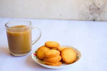 breakfast menu in the form of Danish butter cake and a glass of chocolate milk, Close up of butter cookies coated with white sugar and a glass of chocolate, sweet cake