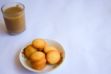 breakfast menu in the form of Danish butter cake and a glass of chocolate milk, Close up of butter cookies coated with white sugar and a glass of chocolate, sweet cake