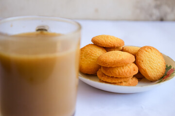 breakfast menu in the form of Danish butter cake and a glass of chocolate milk, Close up of butter cookies coated with white sugar and a glass of chocolate, sweet cake