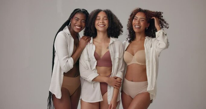 Underwear, diversity and happy women in studio for wellness, beauty and body positivity. Lingerie, group and portrait of people hug in bra with confidence, natural and inclusion on gray background