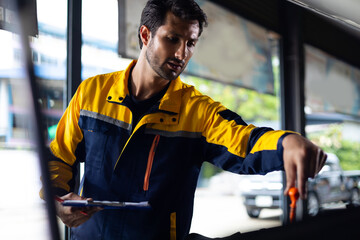 hispanic latin male mechanic repairs car in garage. Closeup hand. Auto car mechanic checking the oil level of the car engine. Car repair and maintenance