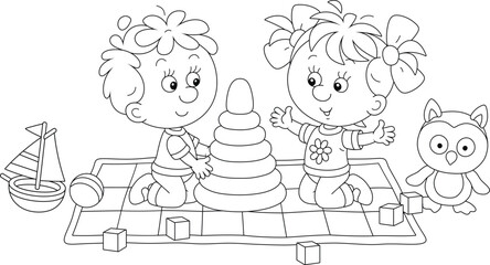 Happy little boy and girl playing with a stacking rings among funny toys on a carpet in a playroom, black and white outline vector cartoon illustration for a coloring book