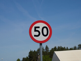 Traffic sign speed limit 50 kilometers per hour on the road.