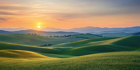 Obraz premium Serene landscape at sunset featuring rolling hills and vibrant green grass, evoking tranquility and natural beauty.