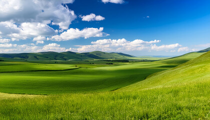 View of mountains and green hills. Countryside nature landscape with blue sky and white clouds. Background for lush nature concept. Serenity and environment concept.