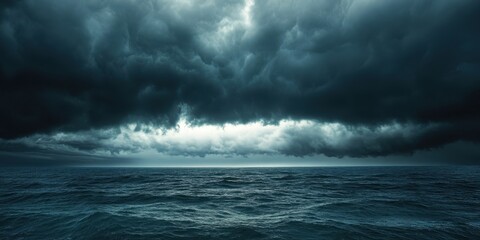 Obraz premium A dramatic seascape featuring dark clouds looming over a turbulent ocean, evoking a sense of mystery and impending weather changes.
