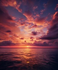 A breathtaking sunset over the ocean, with vibrant hues of orange, pink, and purple reflecting on the calm waters.