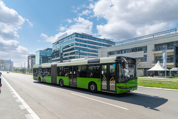 Modern green bus on the city street