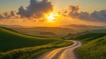 A breathtaking sunset casts a warm glow over a winding road meandering through lush green hills. 