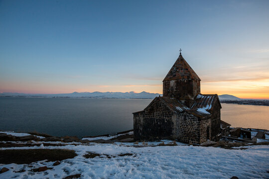 church on lake sevan at sunset in armenia