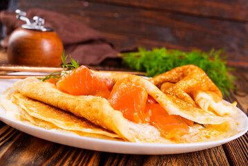 Pancakes with salmon (trout). Thin, not sweet blinchiki stuffed with red fish.