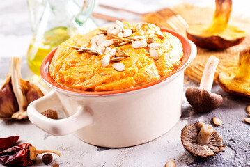 Vegetarian autumn pumpkin cream soup with mushrooms and seeds