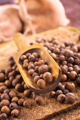 Pile of Black peppercorns seeds on stone board