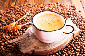 Cup of coffee on wooden background.