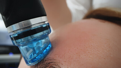 A professional cosmetologist performs hydropeeling and hydrafacial on the client, providing...