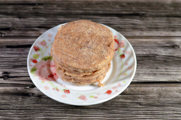 Raw uncooked beef burger ready to be cooked and fried in shallow oil, Fast food, Junk food concept, Home made fast food, beef meat burger ready for frying and served in a burger bun, selective focus