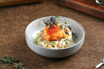 Portion of gourmet olivier salad with red caviar