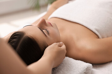 Fototapeta premium Attractive woman enjoying face massage, closeup. Beauty procedure