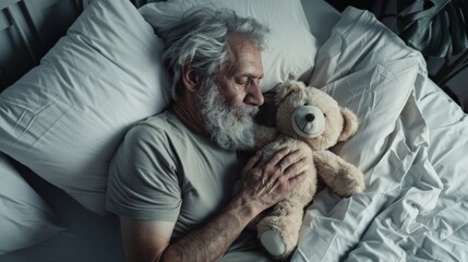 Fototapeta premium An older man, with closed eyes and a gentle expression, hugs a teddy bear while napping in bed, exuding deep tranquility and nostalgia.
