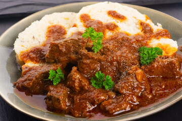 Beef goulash and dumplings (knedliky) on table