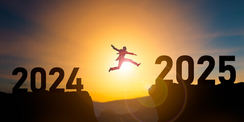 Happy new year 2025,Silhouette BusinessMan jumping from 2024 cliff to 2025 cliff on sky...