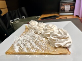 Crepe with whipped cream and powdered sugar