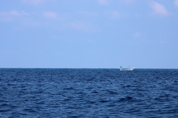 Fototapeta premium A small fishing boat in the middle of the sea