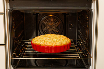 Closeup homemade pie baked in a home oven. Shallow focus.