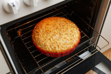 Closeup homemade pie baked in a home oven. Shallow focus.