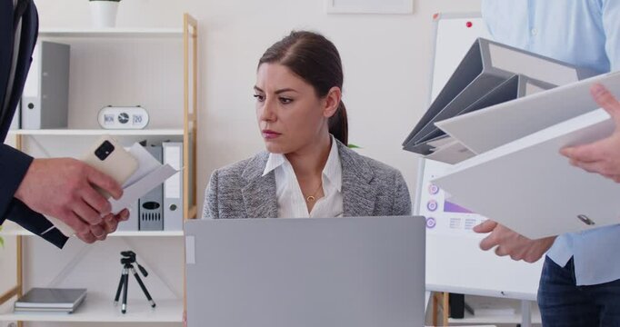 Businesswoman very tired of office work. Busy woman stressed, shocked and terrified by multiple tasks and paperwork load. Team of workers asking boss to answer business calls and sign lot of docs asap