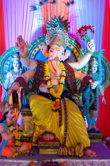 Naklejka premium A Closeup shot Ganpati Installed in a Pandal during the 10 Day Ganesh Festival, the idols are immersed in heavy water bodies after the 10 days.