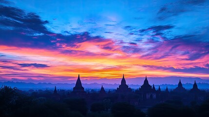 A panoramic view of Bagan at sunset, with the temples silhouetted against a vibrant sky.