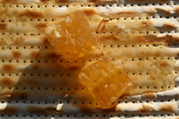 Jewish matzah with honey and honeycomb, close-up photo