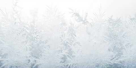 Obraz premium The texture of ice patterns on the window glass in winter frost. Christmas background with frosty pattern.