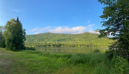 Fototapeta premium Reflective lake surrounded by mountain