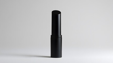 Obraz premium Matte Lipstick Tube: A matte black lipstick tube standing upright on a white background, with minimal reflections and clean lines. 