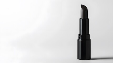 Obraz premium Matte Lipstick Tube: A matte black lipstick tube standing upright on a white background, with minimal reflections and clean lines. 
