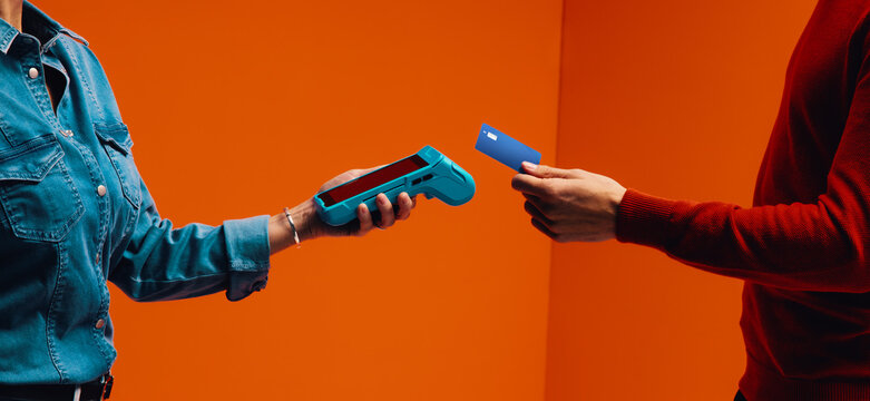 Cashless payment with card reader in retail setting, showcasing digital and wireless transaction