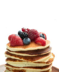 Stack of homemade american pancakes with berries . Top view