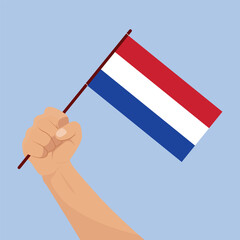 Hand holding Netherland national flag