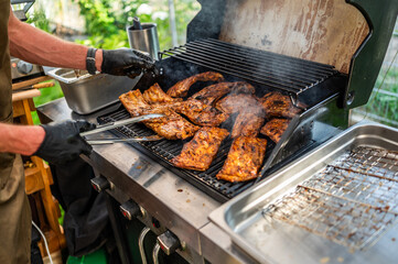 chef is grilling ribs on the grill