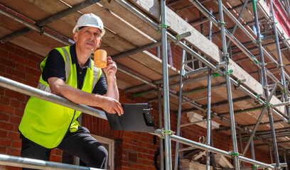 Construction Worker Builder on Building Site Clipboard and Mug