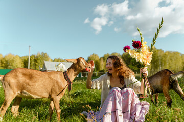 Rural scene of woman feeding goats, embodying harmony with nature and simple, eco-conscious...