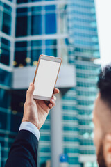 Anonymous manager taking photo of downtown